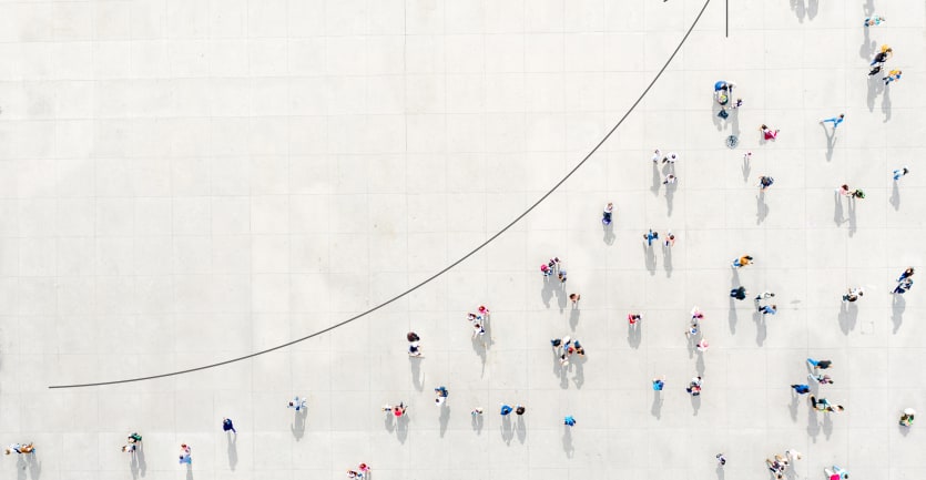 A photo-illustration reveals an overhead shot of scattered groups of people on a white gridded background, aligned along an upward-climbing arrow.