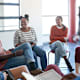 Black and African-American students sitting in a circle and having a discussion during a college mental health support group.