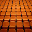 Empty seats in a college lecture hall.