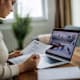 Woman reviewing her resume while searching for jobs online on her laptop