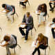 High school students taking the SAT test in a classroom.