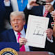 S President Donald Trump displays the signed bill during a ceremony for the One Big Beautiful Bill Act on the South Lawn of the White House in Washington, DC, US, on Friday, July 4, 2025. Trump signed his $3.4 trillion budget bill into law Friday, enshrining an extension of tax cuts, temporary new breaks for tipped workers and funding to crack down on illegal immigration.